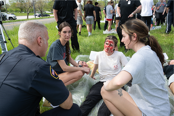 Nursing student with face spattered with fake blood at mass casualty simulation at SIUE